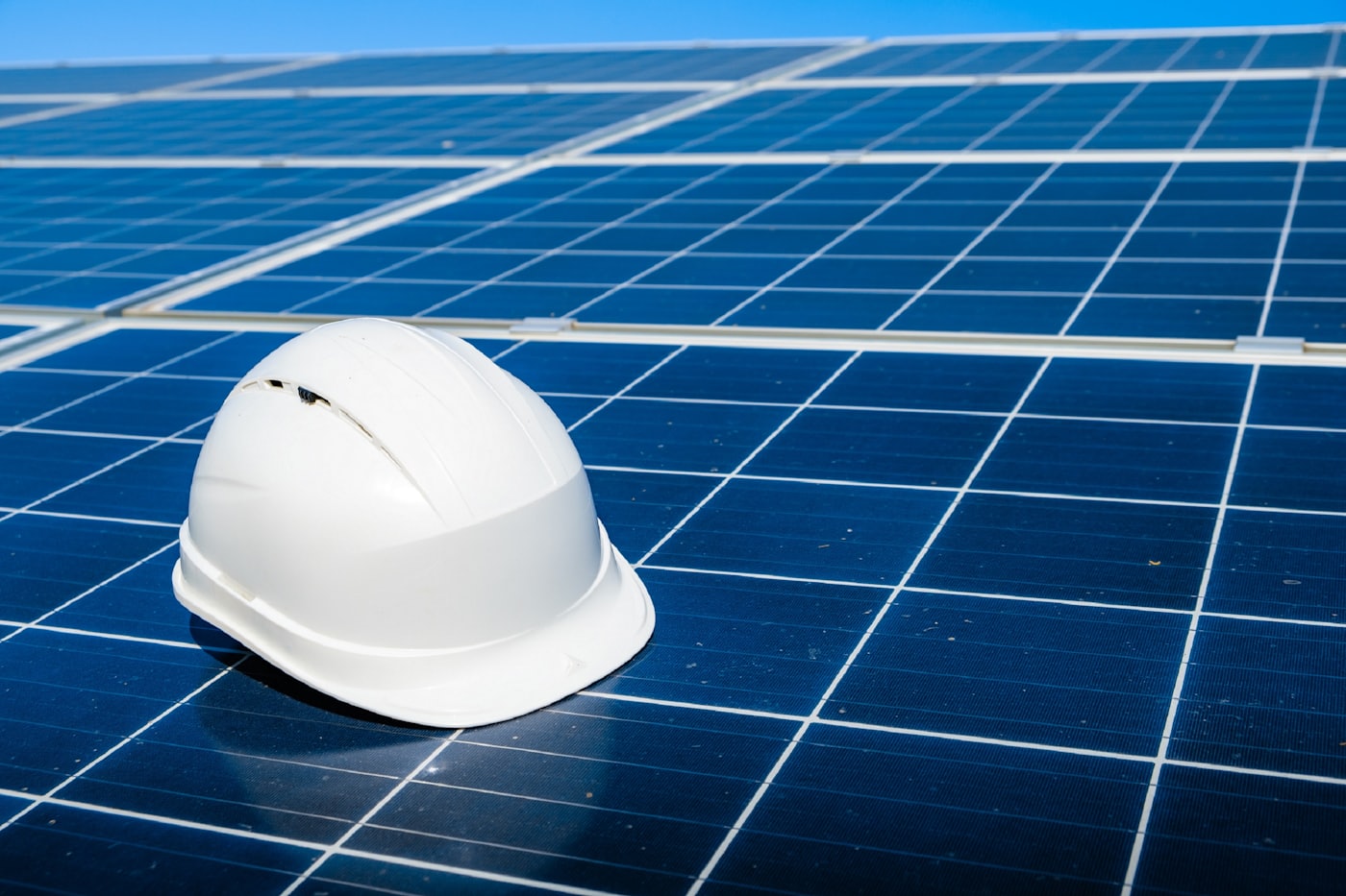Safety helmet resting on a solar module at an installation site