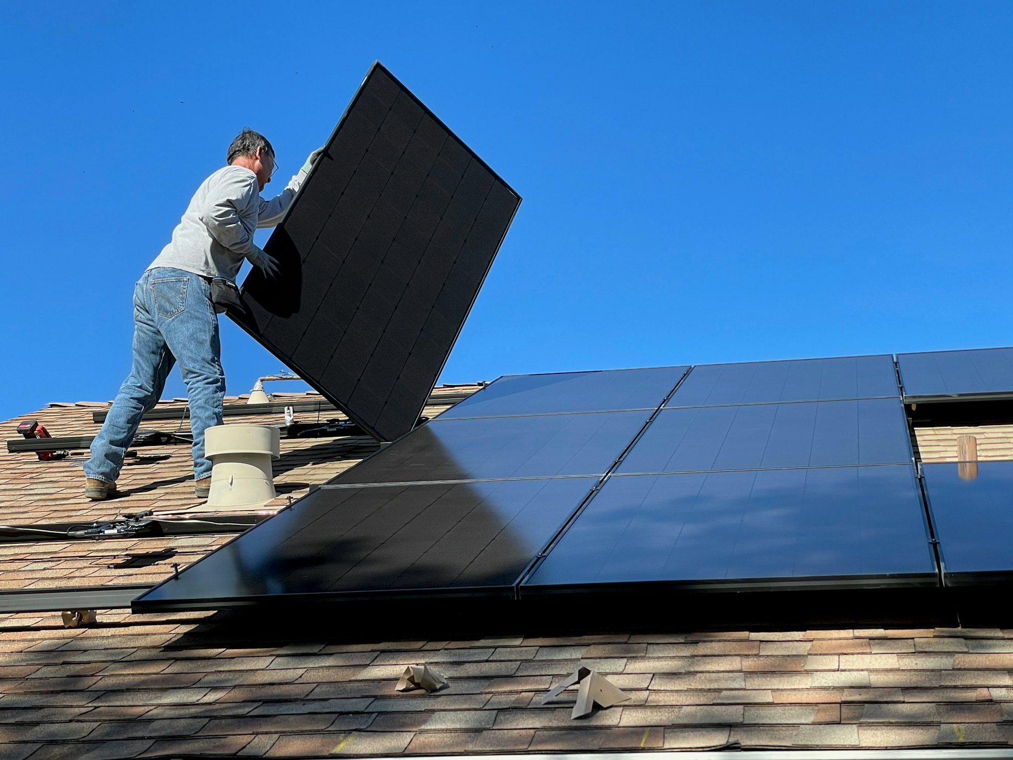 Technician fixing a solar module into position